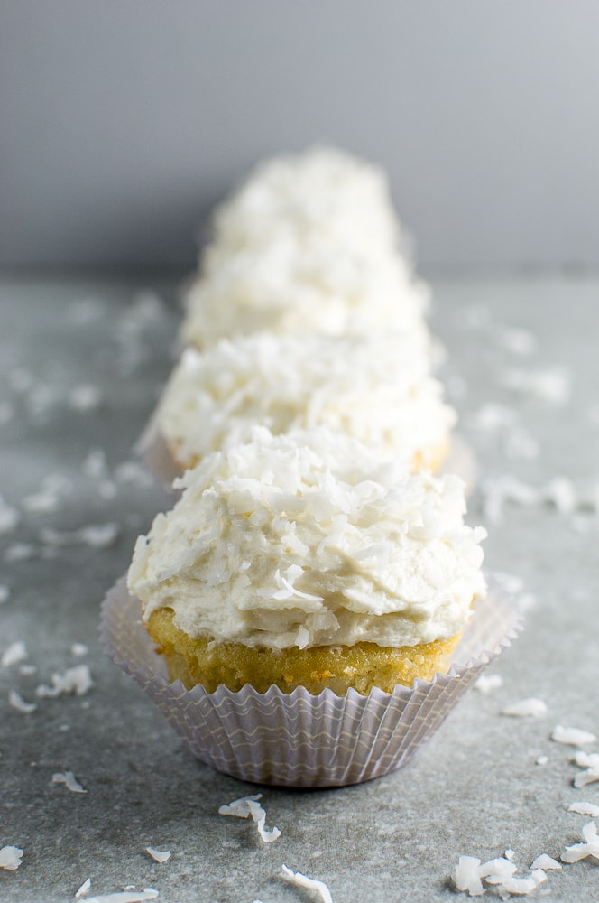 Creamy coconut frosting cupcakes with shredded coconut topping and moist vanilla cake base, perfect for dessert or special occasions.
