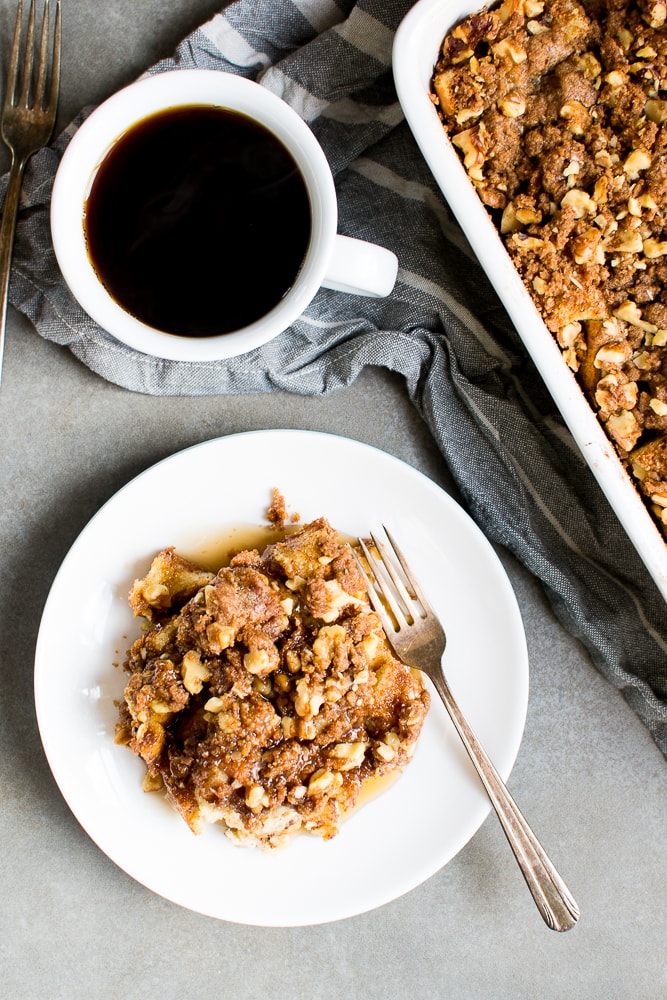 Rich pecan apple crisp served with a cup of black coffee and an extra baked dessert dish in the background, perfect for cozy fall mornings or comforting desserts.