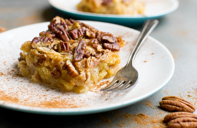 Apple Dump Cake with crispy topping served on a white plate, perfect for breakfast or dessert. Delicious, moist, and easy-to-make gourmet baked good from Stuck On Sweet.