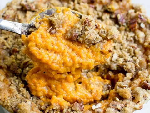 Sweet potato pie filling in a crumbly, pecan-topped pie crust. Perfect for a festive dessert with rich, spiced flavors and a golden brown crust. Great for holidays or special occasions.