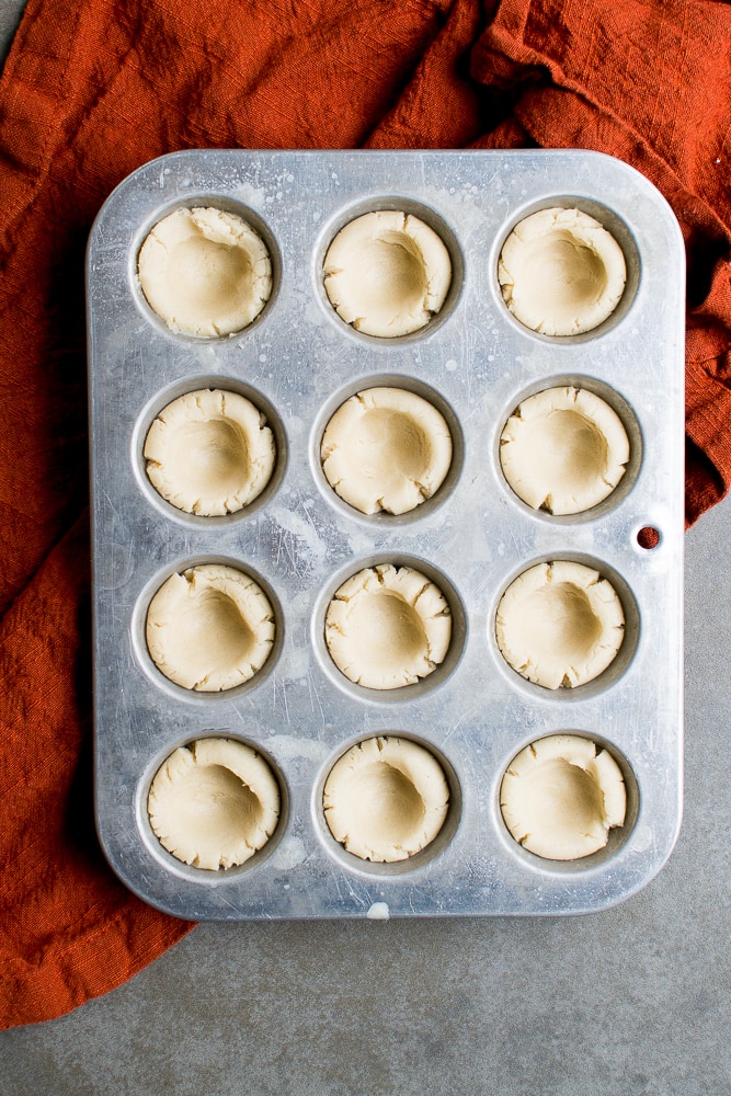 Sweet cookie dough portions in a baking mold for delicious homemade treats.