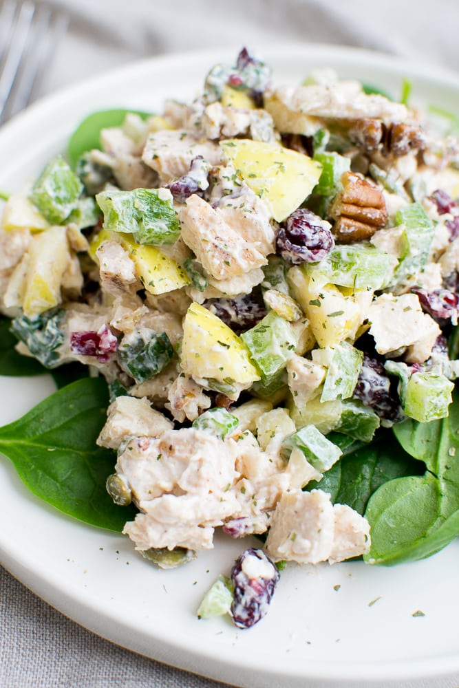 Creamy chicken salad with celery, grapes, and pecans on fresh spinach leaves. Perfect for sandwiches or light lunches, this flavorful salad is easy to make and full of fresh ingredients.