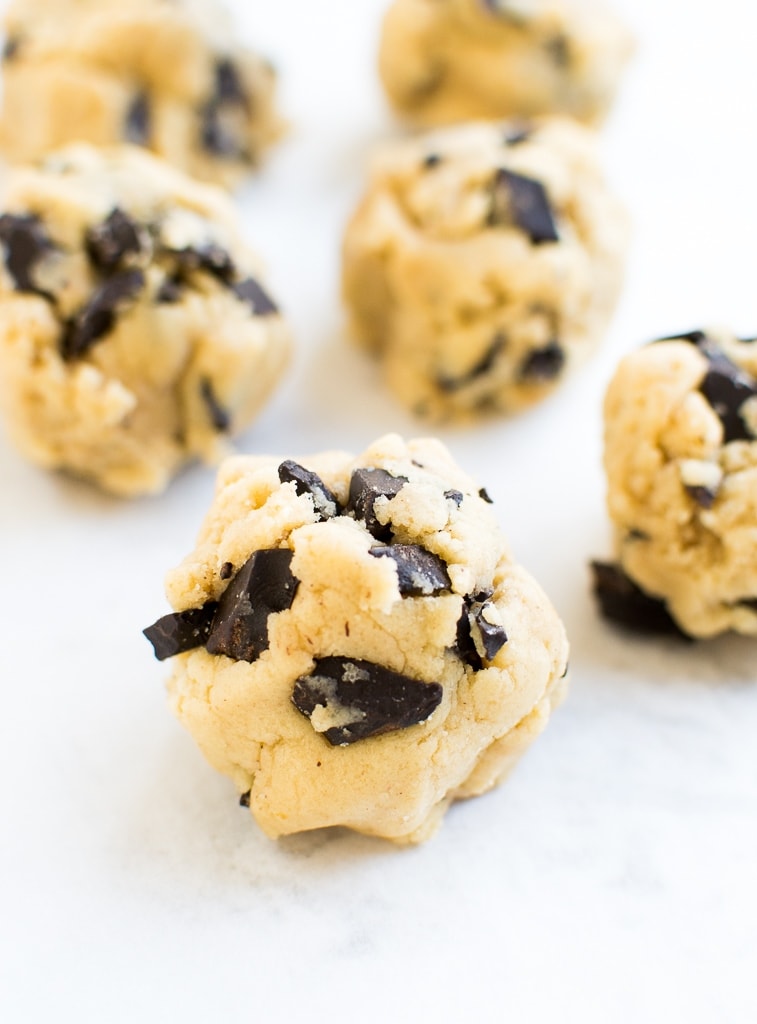 Creamy vanilla cookie dough balls with chocolate chunks, perfect for snacking or gifting, showcasing delicious homemade cookie dough bites from Stuck On Sweet.