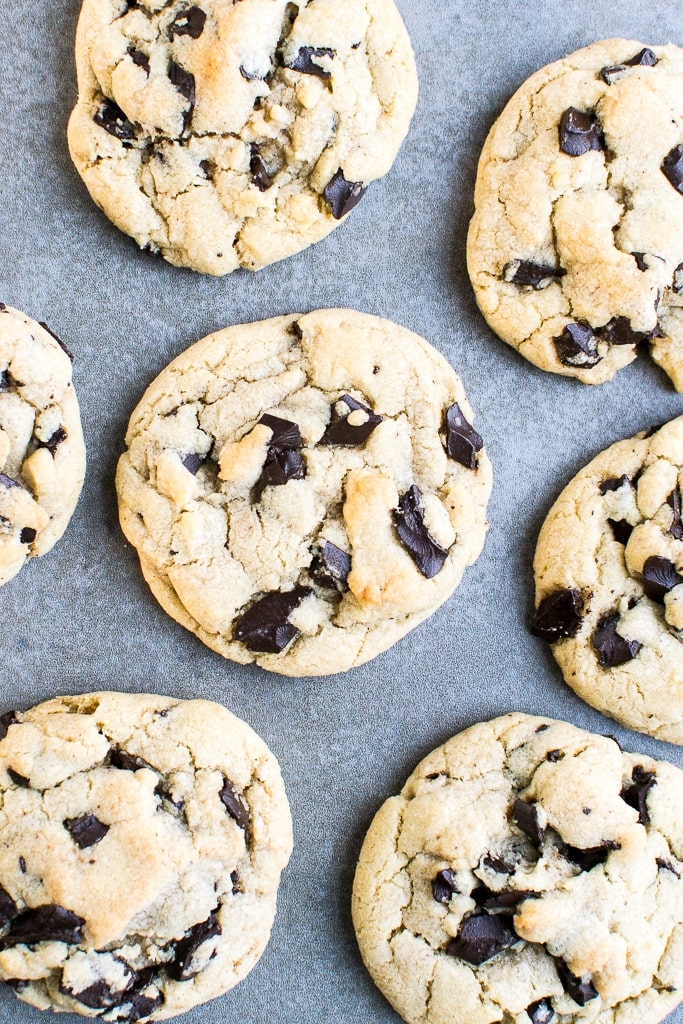 Butter cookies with chocolate chips on baking sheet.