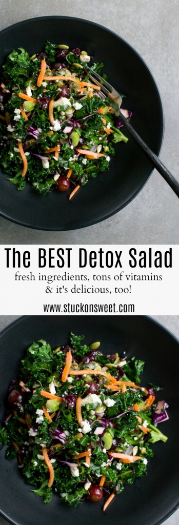 Kale detox salad with carrots, grapes, cheese, and pumpkin seeds in black bowl, healthy fresh vegetable dish for detox, vegan salad recipe, clean eating.