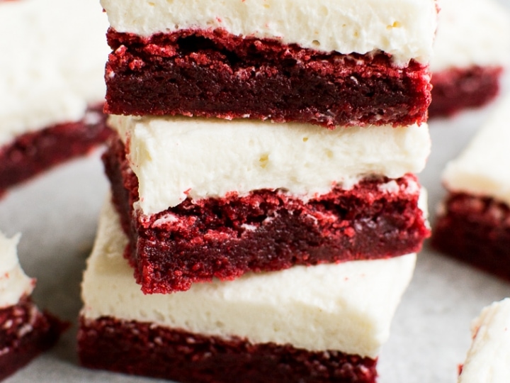 Rich red velvet cheesecake bars with cream cheese frosting, layered for a decadent dessert. Perfect for special occasions and sweet cravings.