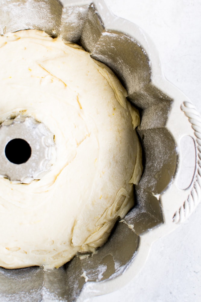Creamy vanilla cake batter in a vintage cake pan ready for baking for delicious homemade birthday cake.
