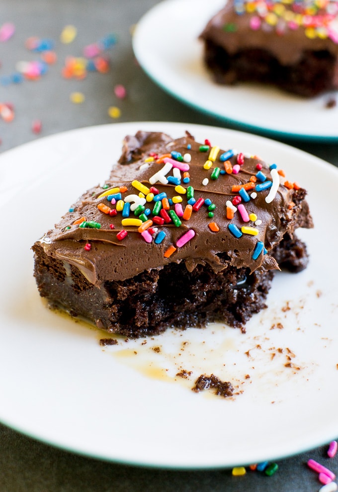 Rich, fudgy chocolate brownie with colorful sprinkles, topped with smooth chocolate frosting; decadent dessert perfect for celebrations or indulgent treats.