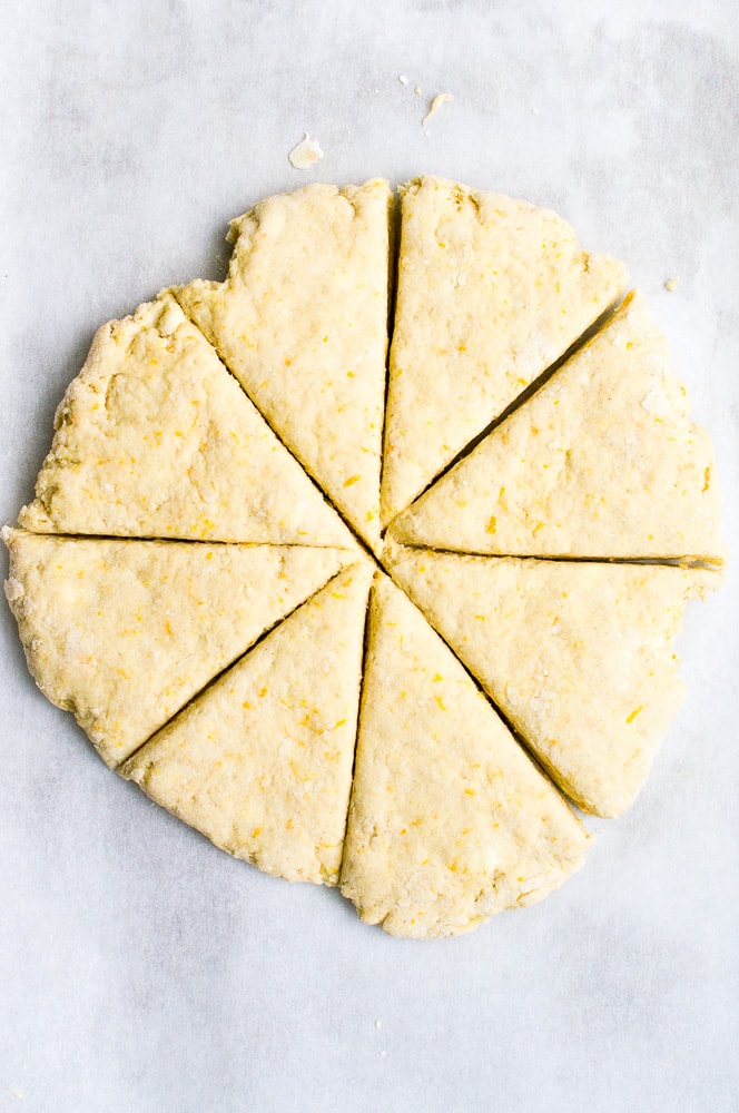 Creamy lemon bars with crumbly crust cut into slices on white background, delicious citrus dessert for spring or summer.