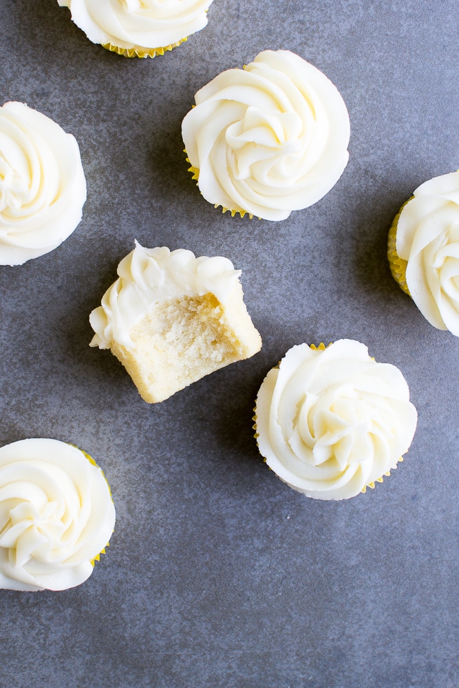 Delicious vanilla cupcakes topped with creamy white frosting, perfect for sweet treats and celebrations.