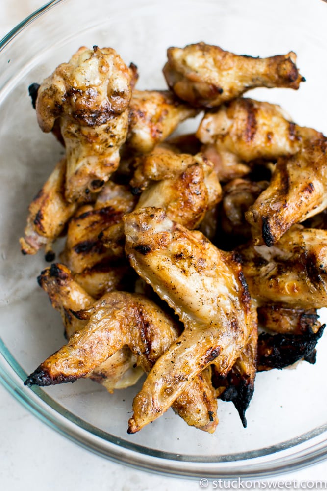 Grilled chicken wings in a glass dish, crispy and flavorful, perfect for appetizers or main course, ideal for outdoor barbecues and gatherings.