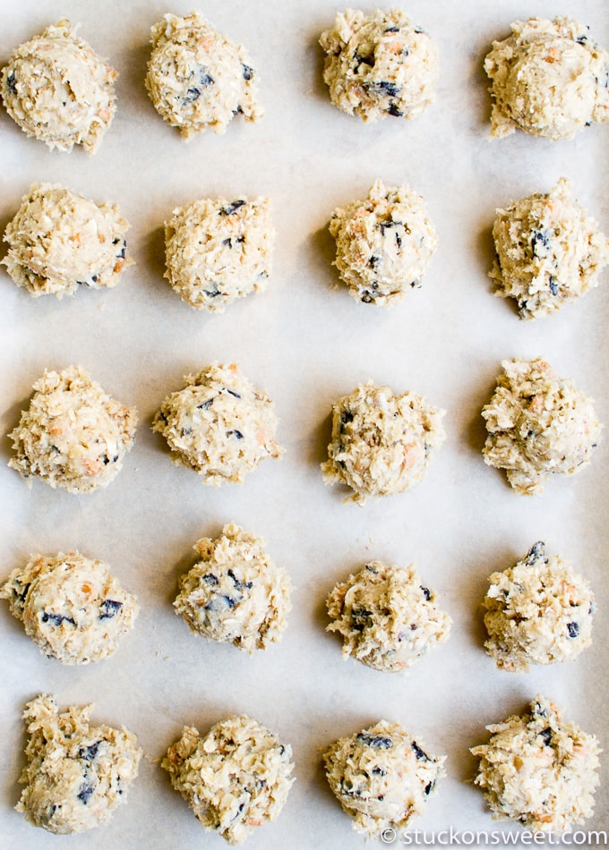 Creamy cookie dough truffles with chocolate chips on baking sheet, ready for baking or chilling. Perfect homemade sweet treats for dessert or party favors.