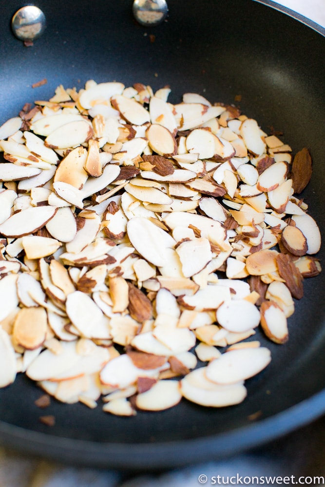 Toasted almond slices in a frying pan.