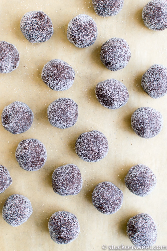 Chocolate cake balls coated in powdered sugar, arranged on parchment paper. Perfect for sweet treats and dessert recipes, these decadent cake balls are ideal for parties and celebrations.