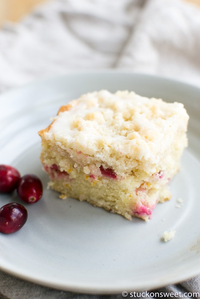 Sweet cherry crumb cake dessert on a white plate with fresh cherries, perfect for easy dessert recipes and bakings.