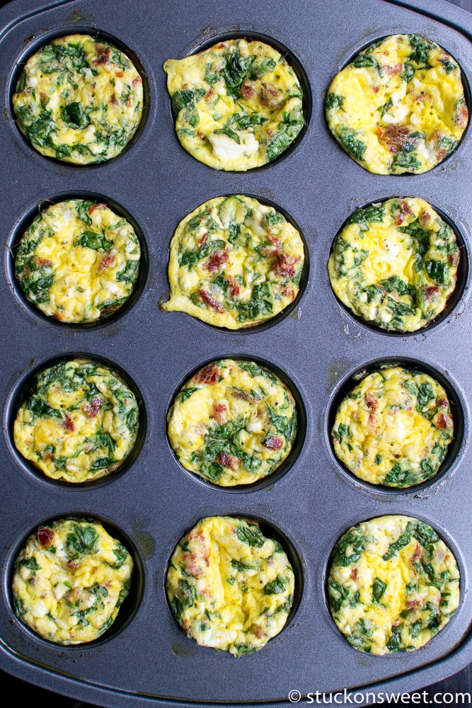 Scrambled egg muffins with spinach and bacon in a muffin tin, fresh and healthy breakfast idea.