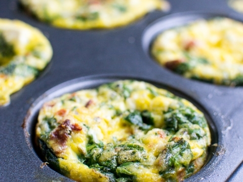 Savory spinach and cheese egg muffins cooked in a muffin tin for a delicious breakfast or snack. Perfect for meal prep, healthy eating, or on-the-go meals with fresh ingredients.
