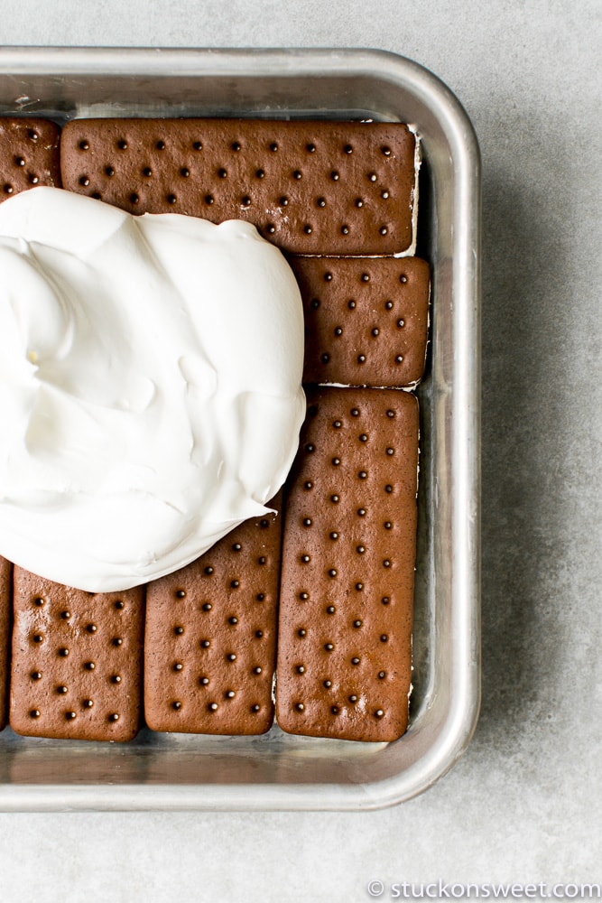 Soft chocolate graham crackers with whipped cream, perfect for s'mores and dessert recipes.