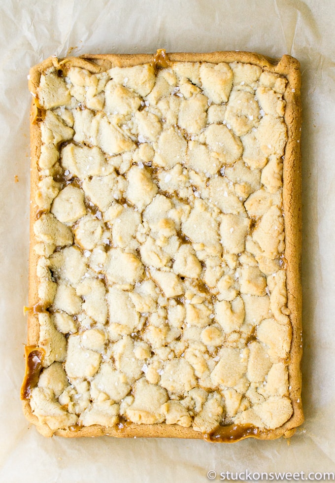 Butterfinger crumble cookie close up, caramel and white chocolate chips on dessert, crispy topping, homemade sweet treat, snack or dessert for sharing.
