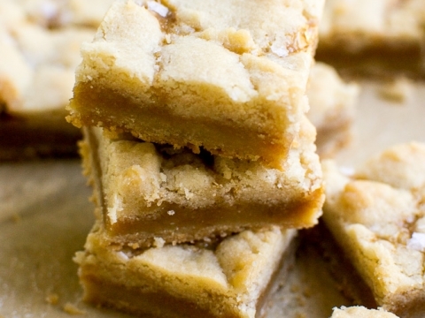 Chewy lemon bar dessert with a crumbly shortbread crust and lemon filling, topped with powdered sugar for a sweet treat. Perfect for springtime and citrus lovers.