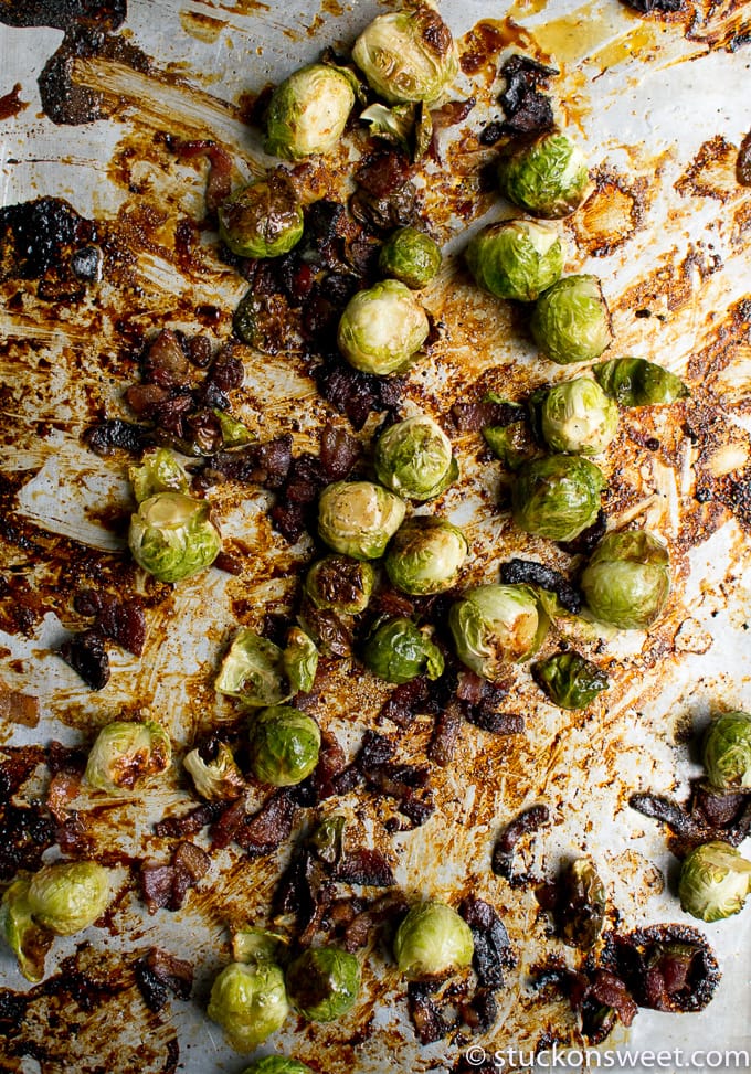 Crunchy roasted Brussels sprouts with caramelized bacon bits on a baking sheet, perfect for a savory vegetable side dish.