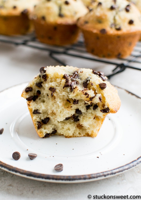 Buttery chocolate chip muffin with gooey chocolate chips on top and a soft, moist crumb, perfect for breakfast or dessert. Delicious homemade muffin recipe from Stuck On Sweet.