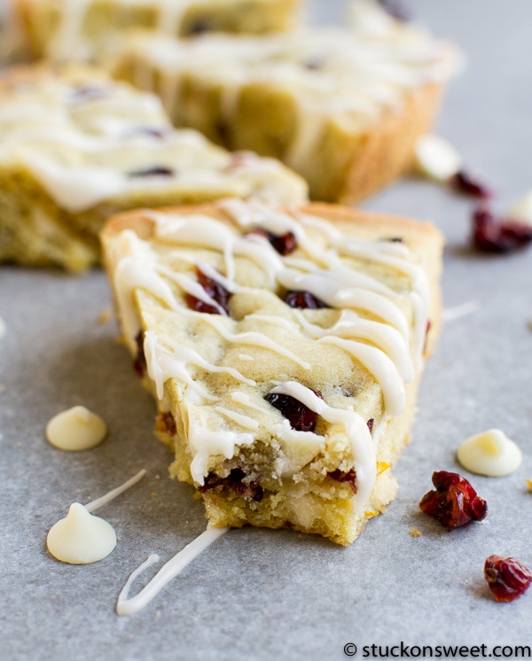 Cream cheese cranberry white chocolate blondie bar with drizzled white chocolate on top, close-up, tasty, delicious dessert, perfect for holiday treats or sweet snacking.