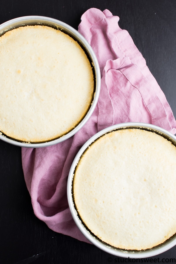 Creamy cheesecake dessert in round baking dishes on black surface with pink cloth, perfect for cheesecake recipes and sweet treats.