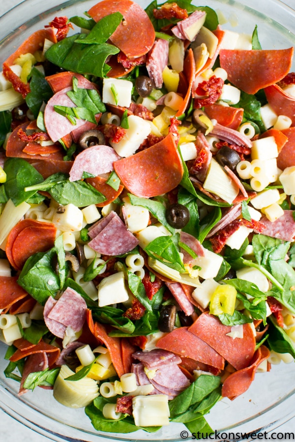 Mixed deli salad with sliced ham, turkey, vegetables, pasta, black olives, and cheese for a flavorful cold dish. Perfect for picnics, lunches, or parties with fresh ingredients and vibrant flavors.