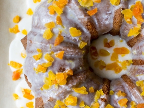 Rich chocolate bundt cake topped with creamy glaze and colorful candied orange peel, perfect for dessert lovers and special occasions.