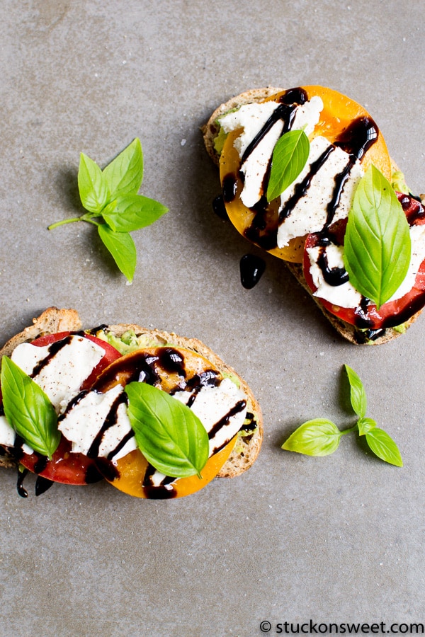 A simple a delicious Avocado Toast recipe comprised of avocado, tomato, mozzarella, basil and balsamic glaze.