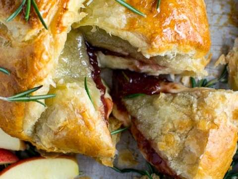 Golden baked ham and cheese pastry with fresh rosemary garnishes and apple slices, perfect for savory snacks or holiday meals. Delicious, flaky, and bursting with flavor.