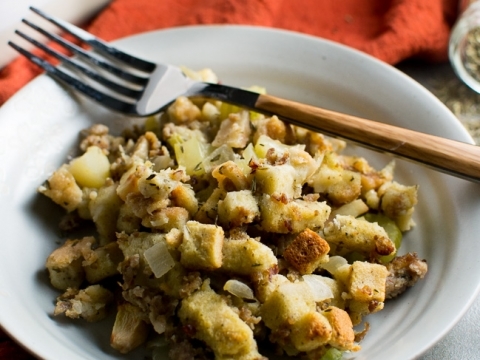 Crispy breakfast hash with potatoes and onions on white plate, fork, rustic kitchen background, comfort food, easy breakfast recipe, Stuck On Sweet.