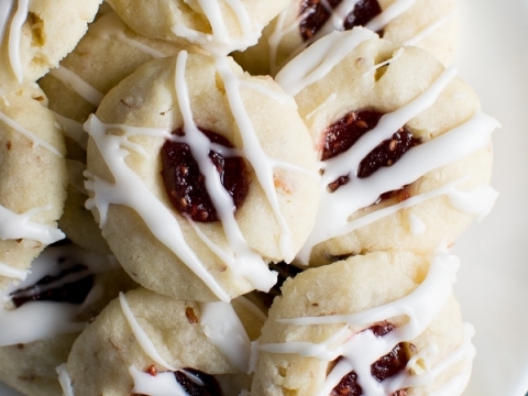 Buttery snowball cookies with chocolate centers drizzled with white chocolate, perfect for holiday desserts and cookie exchanges.