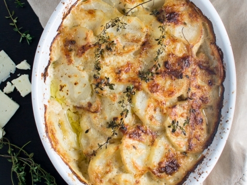 Creamy scalloped potatoes with fresh herbs, baked until golden brown, perfect comfort food for any meal.