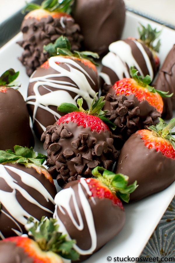Fresh, decadent chocolate-covered strawberries with white and dark chocolate drizzles, topped with chocolate chips, perfect for sweet dessert treats and special occasions.