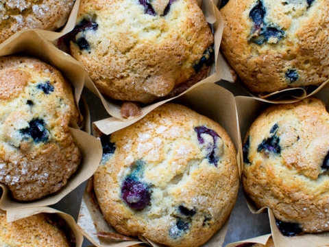 Buttery blueberry muffins with fresh blueberries, golden tops, and soft, moist crumb, perfect for breakfast or snack. Freshly baked blueberry muffins from Stuck On Sweet.