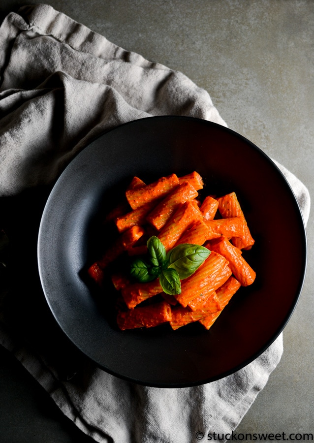 Rigatoni pasta with tomato sauce garnished with basil on black plate, close-up, Italian pasta dish, authentic Italian cuisine, comfort food, Stuck On Sweet.