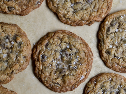 Buttery chocolate chip cookies fresh from the oven, sprinkled with sea salt, showcasing a golden-brown crust and gooey chocolate chips for the ultimate sweet treat.