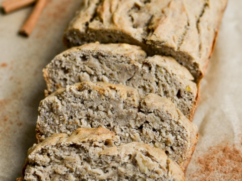 Soft banana nut bread sliced into pieces with cinnamon sticks in the background, perfect for breakfast or snack. Delicious, moist, and filled with flavor, ideal for banana bread lovers.
