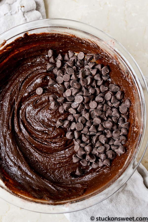 Rich chocolate cake batter with mini chocolate chips mixed in for a delicious homemade dessert.