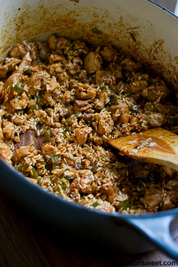 Savory chicken and rice skillet with vegetables, cooked in a flavorful sauce, ready for serving.