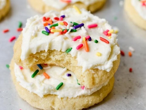 two frosted almond sugar cookies on top of each other