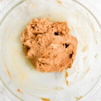 Creamy, soft cookie dough mixture in a glass bowl, perfect for baking cookies or sweet treats. High-quality, fresh cookie dough ready to be baked or chilled for delicious desserts.