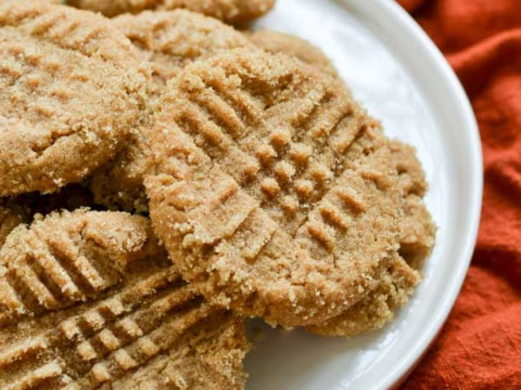 peanut butter cookies on white plate with orange towel