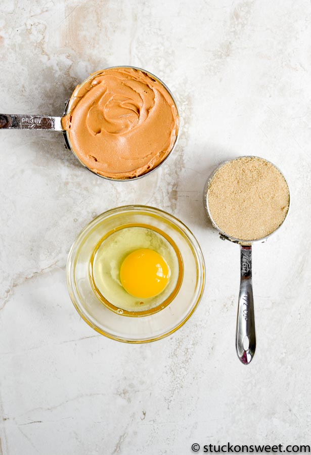 peanut butter, brown sugar, and egg measured on white background