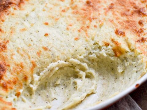 Creamy cheesy scalloped potatoes baked to golden perfection, perfect for comfort food snacks and family dinners. Classic cheesy potato casserole recipe from Stuck On Sweet.