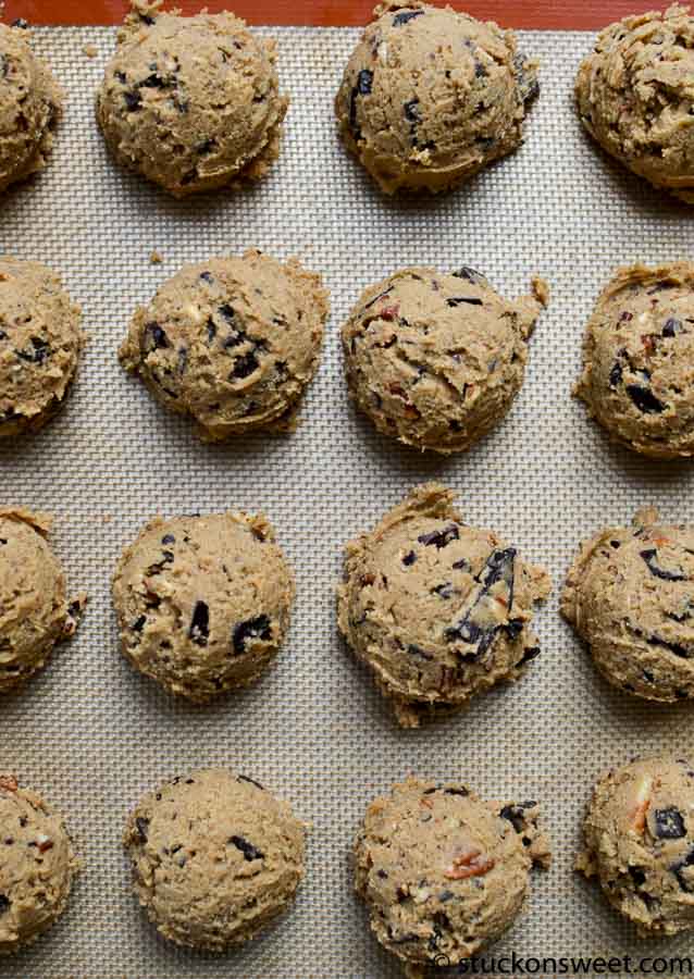 Chewy chocolate chip cookie dough balls on a baking sheet.