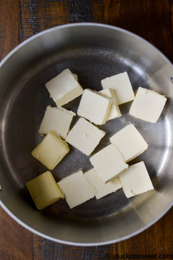 Butter cubes in a stainless steel pan for baking or cooking.