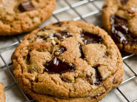picture of a brown butter pecan chocolate chip cookie on cooling rack